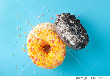 Doughnuts, Chocolate Brown and Pink Donut with Multicolored Sprinkles Doughnuts, Chocolate Brown and Pink Donut with Multicolored Sprinkles 116149826