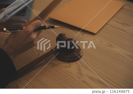 Judge gavel with Justice lawyers having team meeting at law firm background. Concepts of Law and Legal services. 116149875