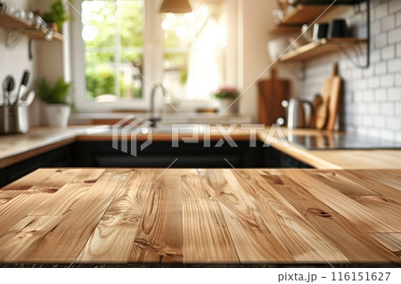 Bright kitchen with a wooden countertop in focus for product montage over blurred modern light interior background, copy space, ideal for promoting kitchenware and home decor. 116151627