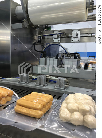 High-performance machines are wrapping processed fresh food products, meatballs sausage.food production lines on conveyor belts, food production industry 116151676