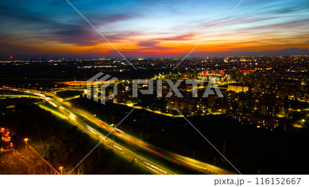 Drone photo huge multi-lane circle roundabout intersection in city traffic highway night city. Public transport commuter pollution business concept. Milan, Italy. Drone photo huge multi-lane circle roundabout intersection in city traffic highway night city. Public transport commuter pollution business concept. Milan, Italy. 116152667