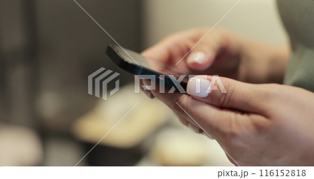 Woman using smartphone at home, typing message. Reading social media internet, typing text or shopping online. Technology, communication concept. 116152818