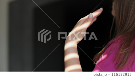 Close up young woman waving her hands because of the heat and turned on the air conditioning. Modern technologies. Close up young woman waving her hands because of the heat and turned on the air conditioning. Modern technologies. 116152913