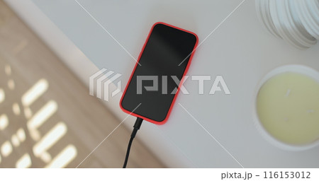 Closeup male hands connecting cable for transfer data. Unrecognizable man plugging cable into smartphone. 116153012
