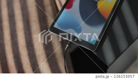 Man hand inserting a charger into a TabletPC. Charging connection to your TabletPC. Man hand inserting a charger into a TabletPC. Charging connection to your TabletPC. 116153057