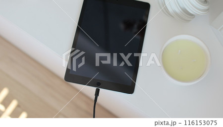 Closeup male hands connecting cable for transfer data. Unrecognizable man plugging cable into Tablet computer. 116153075