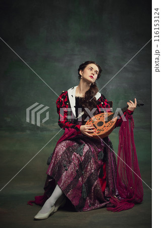 Portrait of beautiful young woman playing with a lute against vintage green background. Renaissance fairs and medieval festivals 116153124