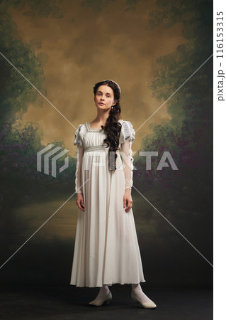 Regency elegance. Portrait of young beautiful woman, medieval princess in white dress standing against vintage background 116153315