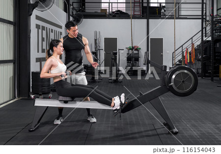 Active couple engaging in a dynamic workout session at the gym.. 116154043