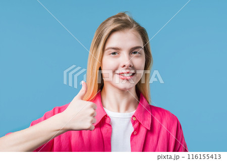 Positive teenager girl with hand sign like,thumbs up gesture.Lady on violet wall Positive teenager girl with hand sign like,thumbs up gesture.Lady on violet wall 116155413