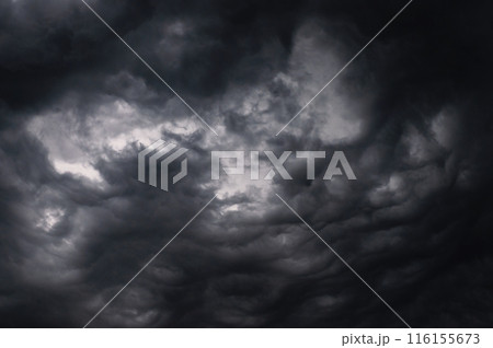 Dark storm clouds gathering in sky creating dramatic scene Dark storm clouds gathering in sky creating dramatic scene 116155673