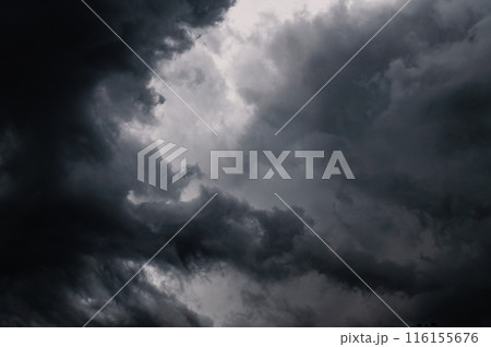 Dark storm clouds gathering in sky creating dramatic scene 116155676