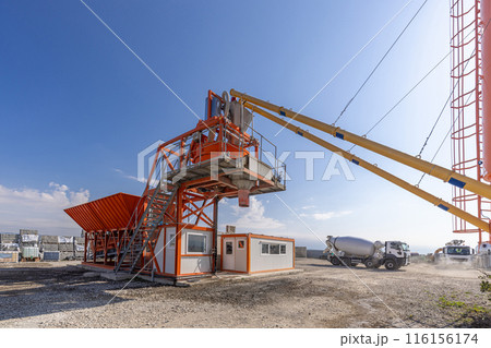Concrete batching plant preparing concrete for a construction project Concrete batching plant preparing concrete for a construction project 116156174