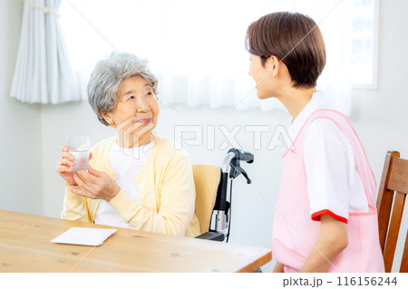 薬を飲むおばあちゃんと介護士 薬を飲むおばあちゃんと介護士 116156244