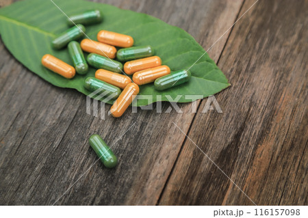 Green herbal capsules from herb for healthy eating in daily life with herb leaf 116157098