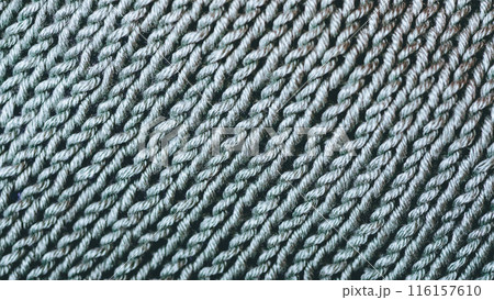 A close up of a knit fabric with a lot of yarn 116157610
