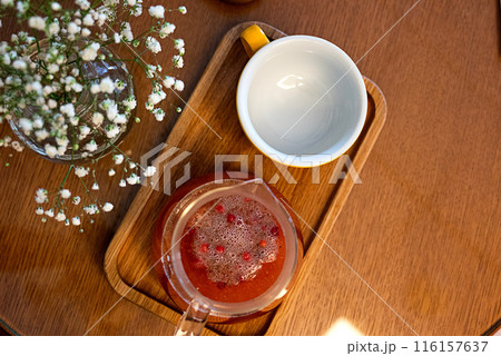 Tea from viburnum in the glass cup with cinnamon and star anise. Close-up. Selective focus. 116157637