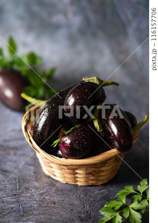 Raw fresh striped eggplants, dark background, rustic style, selective focus, low key 116157706