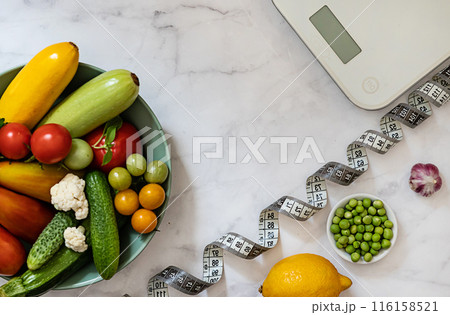Diet plan, menu or program, roulette, water, dumbbells and diet food from fresh fruits on a white background, the concept of weight loss and detoxification, top view 116158521