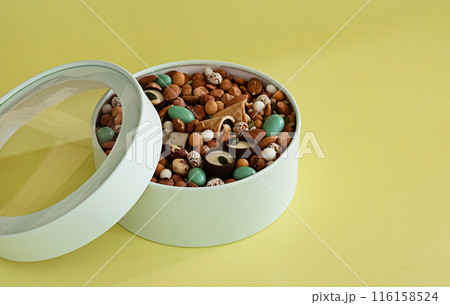 Peanuts in box. Gift to Women's Day (8 March), Women's Day. Mother's Day Valentines day. Festive round box. Peanuts in box. Gift to Women's Day (8 March), Women's Day. Mother's Day Valentines day. Festive round box. 116158524
