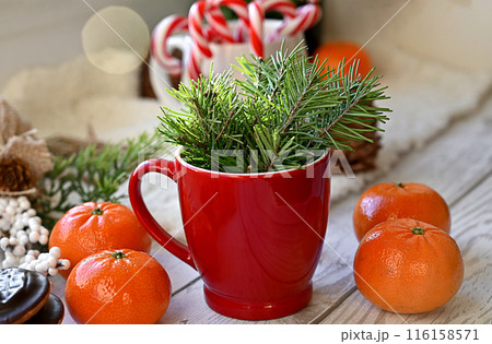 Sweet food top view background for merry christmas or new year holiday decoration - chocolate candies, tangerines, cookies, marshmallow and cocoa latte on white wood 116158571