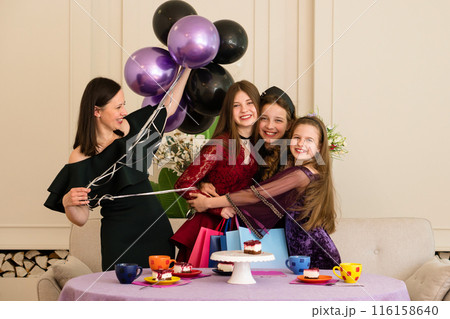 Teen with woman and two young girls. Birthday Party 116158640
