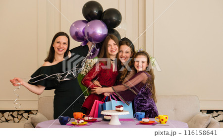 Teen with woman and two young girls. Birthday Party 116158641