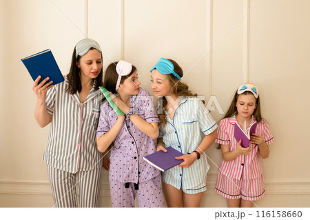 Woman and group girls in striped pajamas holding books 116158660