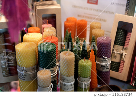 Composition with handmade wax candles, reed diffuser and fruits on color background 116158734