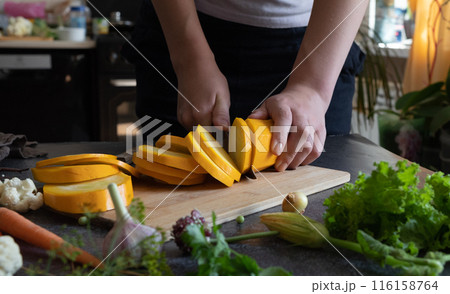 Cook cutting zucchini squash sticks. Close up. 116158764