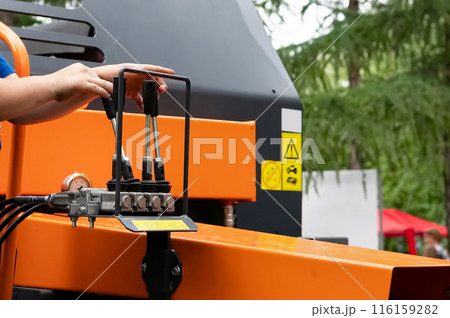 Blue hydraulic equipment close up. Levers for operating hydraulic equipment. Fragment of a blue hydraulic press. Machine tool for heavy industry. Concept - mechanical engineering. 116159282