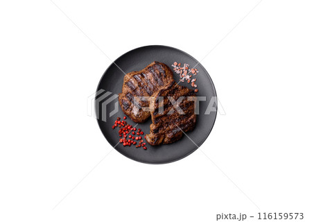Fresh juicy delicious beef steak on a dark background 116159573