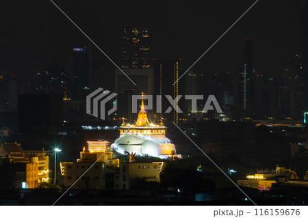 Golden Mountain at Wat Saket Ratcha Worawihan is a Buddhist temple on a mountain at night. It is a tourist landmark of Bangkok, Thailand. Golden Mountain at Wat Saket Ratcha Worawihan is a Buddhist temple on a mountain at night. It is a tourist landmark of Bangkok, Thailand. 116159676
