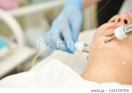 Dermatology anti age treatment. Microcurrent medicine procedure. Woman 116159769
