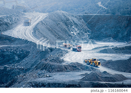 Diabase quarry in Parekklisia, Cyprus with heavy trucks and excavators in operation 116160044