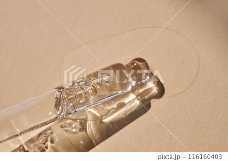 Pipette with serum on a beige background. 116160403