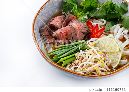 Pho Bo traditional Soup with beef, rice noodles, ginger, lime, chili pepper in bowl. Close up. Vietnamese and Asian cuisine. Pho Bo traditional Soup with beef, rice noodles, ginger, lime, chili pepper in bowl. Close up. Vietnamese and Asian cuisine. 116160781