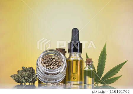 Cbd hemp oil in bottle and marijuana leaves Cbd hemp oil in bottle and marijuana leaves 116161763