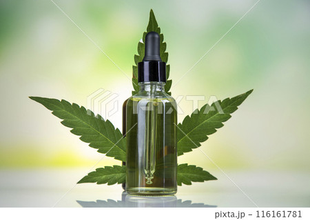 Hemp oil and marijuana leaves on hemp extract, cbd Hemp oil and marijuana leaves on hemp extract, cbd 116161781