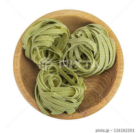 Raw tagliatelle green pasta with spinach in a wooden bowl isolated on white background. Top view. Flat lay. 116162201