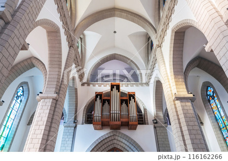 interior of Christian Catholic church with organ pipes on the wall. Sacred Heart of Jesus Cathedral in Tashkent interior of Christian Catholic church with organ pipes on the wall. Sacred Heart of Jesus Cathedral in Tashkent 116162266