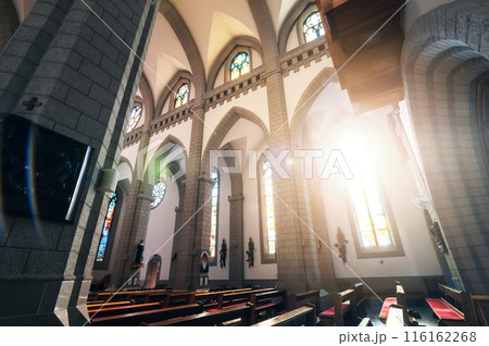 interior of Christian Catholic church with benches and sunlight. Sacred Heart of Jesus Cathedral in Tashkent in Uzbekistan 116162268