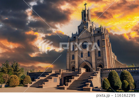 exterior of ancient Catholic Church in the Gothic style. Cathedral of Sacred Heart of Jesus in Tashkent in Uzbekistan on background of dramatic cloudy sky 116162295