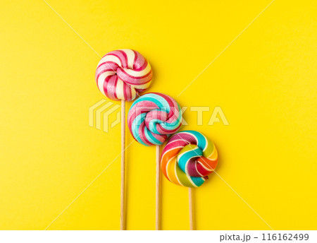 Color lollipop, spiral candy on stick, colorful striped lollypop, round fruit caramel, circle lollipop 116162499