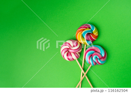 Color lollipop, spiral candy on stick, colorful striped lollypop, round fruit caramel, circle lollipop 116162504