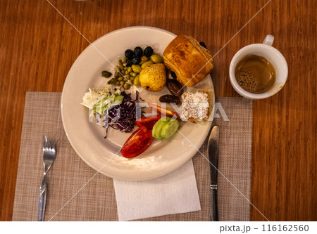 Moroccan hotel breakfast also known as ftour, msemen, coffee, fruits, harcha, mint tea, bread Moroccan hotel breakfast also known as ftour, msemen, coffee, fruits, harcha, mint tea, bread 116162560