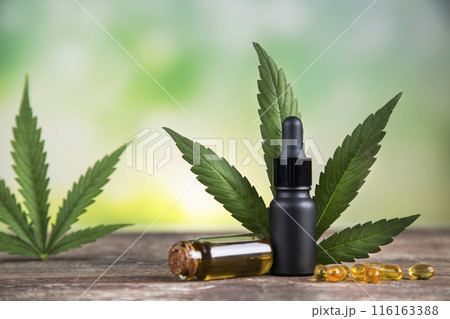 Bottles with hemp oil and cannabis leaves, marijuana 116163388