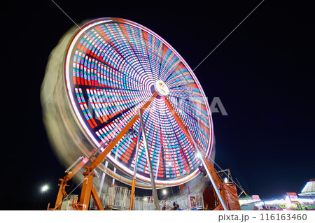 Ferris Wheel Light Trails at Night, Carnival Energy, Low Angle View 116163460