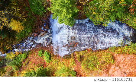 Aerial Top Down Autumn Waterfall in Vibrant Forest Canopy Aerial Top Down Autumn Waterfall in Vibrant Forest Canopy 116163732
