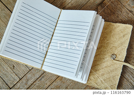 Artisanal Suede Leather Notebook on Wooden Surface, Top View 116163790